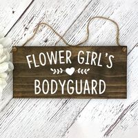 "Flower Girl's Bodyguard Perfect for your cute ring bearer to carry down the isle! This is a sure way to bring smiles to your guests and will be an adorable Wedding Photo Prop. We offer two COLLECTIONS of WEDDING SIGNS.  Below is a link to view each style. WEDDING SIGNS - STYLE A https://www.etsy.com/shop/RustyArrowCreations?ref=simple-shop-header-name&listing_id=678883784&section_id=37730170 WEDDING SIGNS - STYLE B  https://www.etsy.com/shop/RustyArrowCreations?ref=simple-shop-header-name&listing_id=678883784&section_id=37742403 View below options in listing photos SIZE/MATERIAL: 12\"x5.5\"x1/2\" Pine STAIN COLORS: Walnut or Gray DESIGN ELEMENT: Heart/Leaves or Heart/Arrows DESIGN: Hand painted with several coats of white paint OPTIONS FOR HANDLE: White Satin, Twine, No Holes - Handle is