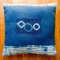 Shibori dyed linen pillow with hand-stitched boro patch