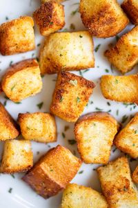 Air Fryer Garlic Croutons are easy to make and a crunchy addition to salads or soups! These croutons crisp up perfectly in an air fryer and have just the right amount of garlic flavor. They are a perfect use for leftover, day-old, or slightly stale bread!