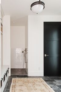 Mudroom with dog shower, vintage rug | Modern Lakehouse by Studio McGee