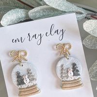 Em Ray Clay on Instagram: "Snow globes, but for your ears ❄️⛄️ I just adore this pair! These + so many more will be coming to the site on November 5th @ 6pm et! #snowglobe #snowglobes #christmassnowglobe #snowman #snowmanearrings #snowglobeearrings #snowflakeearrings #wintervibes #winterearrings #christmascollection #christmasearrings #festivejewelry #festiveearrings #christmas2023 #snowmen #snowglobecollection #christmassy #christmasthings #christmaspolymerclayearrings #christmasclayearring