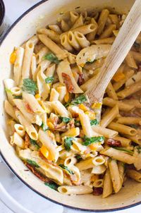 This healthy one-pot Tuscan Chicken Pasta recipe is creamy, cheesy, and garlicky yet packed with Tuscan flavors with the addition of sun-dried tomatoes, spinach, garlic, and chicken! Plus, this healthy chicken pasta recipe can also be prepared gluten-free and/or dairy-free and is ready in under 30 minutes!