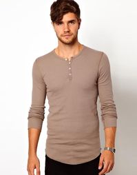 This is an example of a henley shirt, which is a collarless pullover shirt, characterized by a (4") placket beneath the round neckline, usually having 2–5 buttons. (It essentially resembles a collarless polo shirt.)