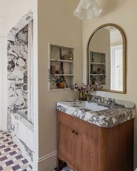 Katie Conway Monkhouse on Instagram: "One of favorite little bathrooms we’ve designed 🖤 A ‘Jack and Jill’ connecting two sisters bedrooms. Updated with playful but sophisticated finishes. This little bathroom fits in perfectly with old SF charm of the rest of the house. 

Swipe for before (and yes, we thought it was cute too - just not functional for kids and pretty old ;-)

As seen in @vogueliving 

Photo @stephaniecrusso 
Styling @rachel_forslund 
Build @themeticuloushandyman 
Design @katiemonkhouseinteriors"