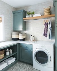 A new classic laundry room remodel with clay tiles, green cabinets, and patterned tile flooring | Studio McGee Blog