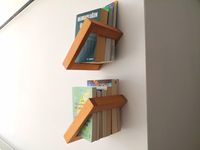 This floating bookshelf is perfect for homes and offices or as a housewarming gift/office warming gift. The wall-mounted design saves space. Designed to carry heavy books with invisible screwdrivers.  FREE EXPRESS SHIPPING You can design your wall with different numbers of reversible shelves. Your imagination is the limit. Product Dimensions Height: 24centimeter (9.5 inches) Thickness: 4.5 centimeters (1.8 inches)  Width: 24 centimeters (9.5 inches) No decoration included. NESTWOOD products are