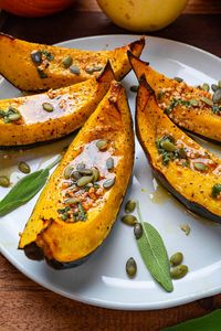 Sweet roasted acorn squash wedges drizzled in browned butter, garlic and sage!