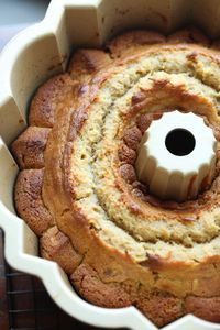 This deliciously moist banana pound cake is made with ripe bananas and crunchy chopped walnuts! Top it with an easy homemade vanilla glaze and enjoy! #cookiesandcups #bananacake #poundcake