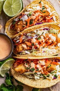 Wrapped in warm corn tortillas, these crunchy mahi mahi fish tacos with homemade batter are the coastal twist your summer meals were missing. Served with creamy, spicy, and veggie toppings, they're a seafood fiesta in every bite!