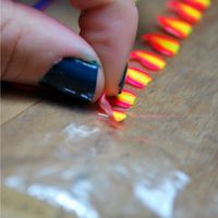 Ever wanted to paint pretty designs on your nails and then realized that it was impossible to do yourself because you have a dominant hand? Paint the designs onto a ziploc bag and then peel them off and place them on your nail!! Finish with top coat :)    Whoa..