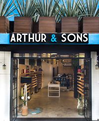 Modern Commercial Space | Eyewear store, huge potted plants (agave), black metal frame glass doors, concrete floor with mosaic application and light wood displays | Mexico City #HuacalEstudio #EyeWear #CoolStore