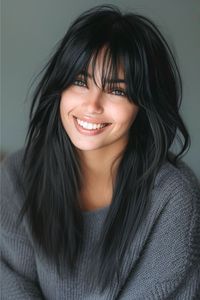 Pitch-black strands with strategic layers offer a refreshing take on classic long hair. Strategic layering around the face softens the straight cut. Click here to see more stunning long layered hair with bangs ideas.