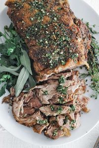 This tasty, tender, flavorful Pork Shoulder Roast is golden brown and served with a delicious herb and garlic sauce. 