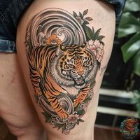 Discover the allure of Japanese tattoo art with this enchanting tiger tattoo. Featuring a tiger surrounded by lush flowers and curling waves, this design combines beauty with the beastly, perfect for anyone looking to blend elegance with edge. Check out more designs at inktat2.com.