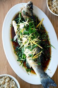 Truly, this is one of the most delicious fish recipes I have ever made: Chinese-style whole Branzino with ginger, scallions, cilantro and soy. It's restaurant quality, but easy to pull off at home, and utterly delicious. Steaming fish whole is so forgiving — the fish rarely gets overcooked, it stays hot, the flesh is moist. It's sooo good. Love it with brown rice. #fish #branzino #Chinese #scallions #ginger #cilantro #soy #sesame