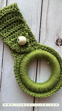 Crochet wood ring towel holder for kitchen or bath towels. This quick and easy holder uses a button or bead closure. Work up a few to display and hold your towels securely.