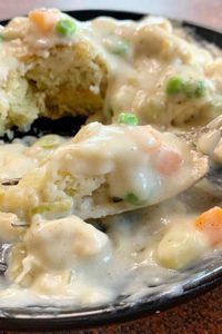 Creamy, savory, and comforting all describe this easy Chicken a la King recipe. A perfect combination of chicken, peas, carrots, celery, and onions in a creamy flavorful gravy. This easy dinner recipe is perfect served over biscuits like shown in my recipe or over rice or mashed potatoes. No matter how you serve it, it’s delicious and filling. #chickenalaking #chicken #dinner