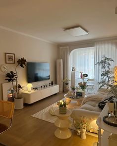 a living room filled with furniture and a flat screen tv