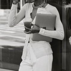 a black and white photo of a woman holding a laptop