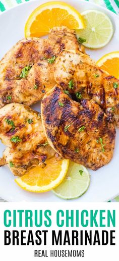 grilled chicken breast marinade on a white plate with lemons and cilantro