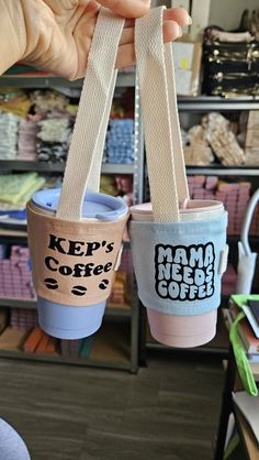 two coffee cups with the words keep's coffee on them are being held up