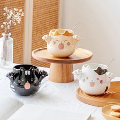 three bowls with faces on them sitting on a table