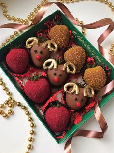 chocolate covered strawberries with gold decorations in a green box