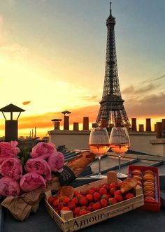 the eiffel tower is in the background with pink flowers and fruit on it