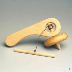 a wooden object with a string attached to it and a piece of wood next to it