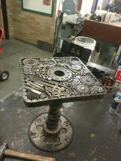 a table made out of gears in a garage