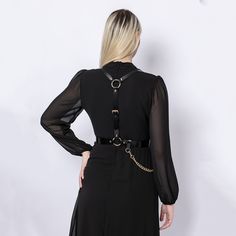 A harness designed to be timeless, the Chained Harness is handcrafted from real Italian leather.  Adjustable at waist and shoulders, the piece beautifully frames the torso, creating a stylish and empowering look. With a detachable chain draping on the waist, you can style the harness over a dress, shirt or even a blazer. Handcrafted in EU using Italian Full Grain Leather and Nickel Plated Hardware        It is recommended to clean the products after each wear as follows:  The leather parts should be wiped with a soft cloth, slightly damp, and let dry at room temperature the metallic elements should be well wiped with a dry cloth  It is NOT recommended to expose the products to heat sources, humidity, water, solutions containing alcohol, fire      Avoid contact with rough or hot surfaces th Gothic Leather Harness With Belt, Edgy Belt Harness For Night Out, Edgy Harness With Belt For Night Out, Party Harness With Belt Loops In Black, Black Party Harness With Belt Loops, Gothic Chain Belt With Chain Strap For Party, Elegant Black Body Chain For Evening, Elegant Fitted Black Harness, Elegant Black Party Harness