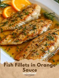 fish fillets in orange sauce on a white plate