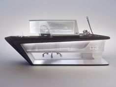 an office desk with a computer on it and a car in the backgroud