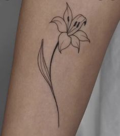 a small flower tattoo on the right side of the leg, which is black and white