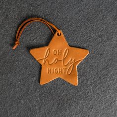 "Celebrate the holidays with this fun O Holy Night Star Shape Leather Christmas Ornament. Crafted from full-grain leather, this round ornament will delightfully hang from your Christmas tree for years to come. Perfect for personalizing your stocking or use as a gift tag, make this season merry and bright! SPECS     *Dimensions: 4.2\" wide by 4\" tall     *Leather Color Options: Choose from Deep Ocean, Harvest, Black, Stone Natural, Brown, or Sienna     *Made in the USA MATERIALS     *REAL LEATHE Leather Christmas Decorations, Texas Christmas Decorations, Texas Christmas Decor, Leather Christmas Ornaments, Lanyard Bracelet, Leather Christmas, Texas Christmas, Stocking Tags, Leather Ideas