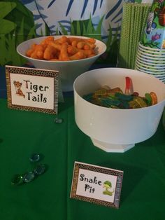 there are two bowls of food on the table with place cards in front of them