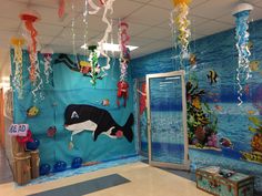 an office decorated with under the sea theme and balloons hanging from the ceiling above it