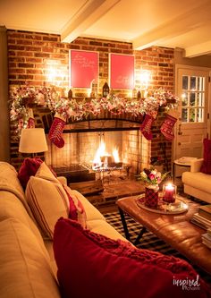 a living room filled with furniture and a fire place in front of a christmas tree