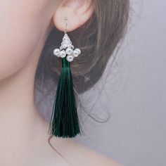 Elevate any outfit with these handmade tassel earrings. Made with premium silk tassels and faux pearl tassel caps, featuring a delicate filigree pattern. A perfect gift for New Year's or Christmas. Style them with a simple dress or blouse for an elegant look, pair with flowy top and denim for a bohemian vibe, or dress up a casual outfit with these statement earrings. Showcase the earrings fully by wearing your hair up, and perfect for special occasion like weddings or parties. ⚜Item Specifics ❀ Silk Tassels, Filigree Pattern, Asymmetrical Earrings, Christmas Style, Simple Dress, Flowy Top, Flowy Tops, Green Silk, Boutique Jewelry