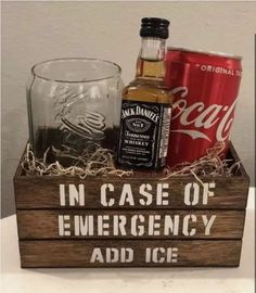 a wooden box filled with liquor and an old fashioned glass sitting on top of a table