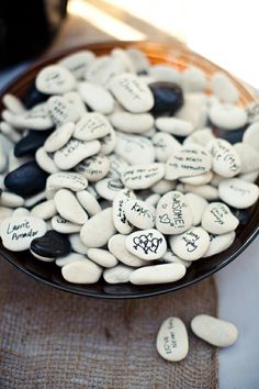 some white and black rocks in a bowl