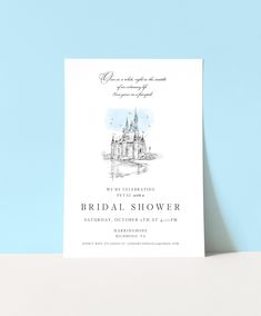 the bridal shower card is displayed on top of a white table next to a blue wall