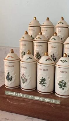 a group of ceramic canisters sitting on top of a table