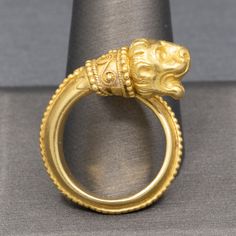 Ilias Lalaounis Greek Chimera Lion Wrap Bypass Ring in 18k Yellow Gold This eternal creature rests with his mouth open as if waiting for the next bite!  This ring by Ilias Lalaounis features one of the maker's most famous motifs.  The tail of the creature wraps around the finger and features granulated baed work on the ridge line of the band.  The 750 mark and the Greece marks are seen under the collar.  The ring is a size 7.5 with a little flex- it would fit a size 7.5-8.  The ring is crafted i Ilias Lalaounis Jewelry, Ancient Yellow Gold Jewelry For Ceremonial Occasions, Ancient Style Yellow Gold Ceremonial Jewelry, Ancient Style Collectible Yellow Gold Rings, Gold Byzantine Carved Jewelry, Byzantine Style Carved Gold Jewelry, Bypass Ring, Ancient Jewelry, Gems And Minerals