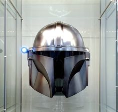 a helmet is in a glass case with light coming from the top and bottom part