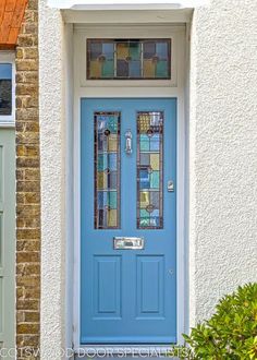 a blue front door with stained glass panels