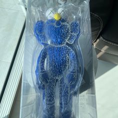 a blue teddy bear is in the packaging