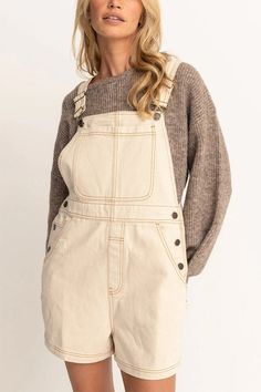 Made for hours of sunshine and summer parties, the natural cotton material makes these overalls light and comfy for any summer plans.   Tides Short Overall by Rhythm  Color: Natural  Material: 100% Cotton  True to size.  Relaxed, easy fit.  Adjustable straps.  Large front pocket with additional side, hip pockets.  Model is wearing a size Small/8. Chevron Sweater, Youth Clothing, Chevron Dress, Overalls Women, Dress Romper, The Girl Who, Overall Shorts, Bra Tops, Bottoms Pants