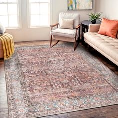 a living room filled with furniture and a large rug