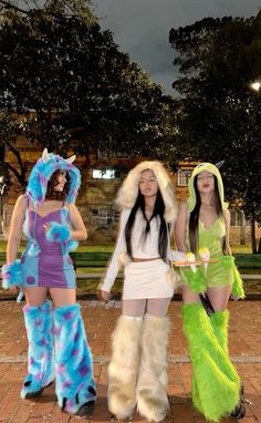 three women dressed in costumes standing next to each other